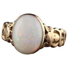 Beautiful Antique Victorian 15K Yellow Gold Opal Asclepios Carved Ring. This gorgeous opal Victorian ring is crafted in 15K yellow gold. The center is a beautiful white opal cabochon with beautiful play of color that is set in a Victorian mounting that has what looks to be a Asclepios figure on each side but is worn. Asclepios was a hero and God of medicine in Greek Mythology. Item #R1295 Metal: 15K Yellow Gold Weight: 6.9 Grams Size: 9 Opal: Approximately 5 ct Measurements: Top of the ring meas Georgian Engagement Ring, Seed Pearl Ring, Pretty Engagement Rings, Victorian Engagement Rings, Victorian Ring, Carved Ring, Gold Cocktail Ring, Victorian Rings, Set Ring