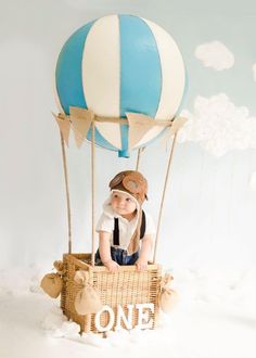 a little boy sitting in a hot air balloon