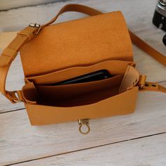 "Every handbag is made with 100% genuine leather. This bag is the perfect helper, you can put a lot of objects in it and your hands and pockets will be free. Size bag: - Length -- 8.6\" (22 cm) - Height -- 6.3\" (16 cm) - Deepth -- 2.7\" (7 cm) ----------------------------------------------------- Each accessory can differ in color from the photo, which makes them unique. Since this is a natural leather, small natural irregularities, like scars, stitches, bumps etc. are not reworked. They emphas Leather Crossbody Phone Bag For Office, Leather Phone Shoulder Bag For Office, Cognac Crossbody Shoulder Bag With Mobile Phone Pocket, Cognac Crossbody Shoulder Bag With Mobile Phone Bag, Leather Shoulder Phone Bag For Office, Cognac Crossbody Shoulder Bag With Mobile Phone Holder, Leather Flap Box Bag For Everyday, Cognac Crossbody Shoulder Bag With Phone Pocket, Leather Clutch Phone Bag With Adjustable Strap