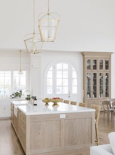 a large kitchen with an island in the middle