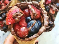 chocolate covered strawberries and blueberries in a cone