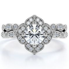 a white gold engagement ring with an oval center surrounded by round brilliant cut diamonds