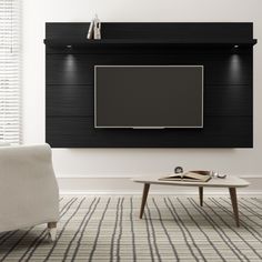 a living room with a large flat screen tv mounted on the wall above a coffee table