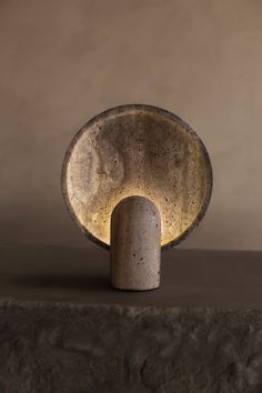 a concrete lamp sitting on top of a table