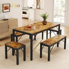 a dining room table with benches in front of it and a potted plant on top