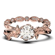 a rose gold wedding ring set with a round diamond center and leaves on the band