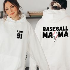 Elevate your game day style with our Custom Baseball Mom Hoodie. This isn't just any sweatshirt - it's a personalized tribute to the love and support you show as a baseball mom. Whether it's for Mother's Day or any day, this custom gift is a home run. Featuring your chosen name and number, it's a one-of-a-kind expression of your pride. Stay cozy and stylish on the sidelines or in the stands with this must-have baseball mom sweater. Order yours today and wear your support with pride! Welcome to V White Varsity Hoodie For College, Sports Fan Apparel Hoodie Sweatshirt, White Team Spirit Sweatshirt For Streetwear, White Team Spirit Streetwear Sweatshirt, Sports Fan Hoodie For Streetwear, White Streetwear Team Spirit Sweatshirt, Throwback Sports Hoodie Top, Game Day Hoodie With Drawstring, White Team Spirit Hoodie For Streetwear