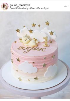 a pink and white cake with gold stars on top is shown in this instagram photo