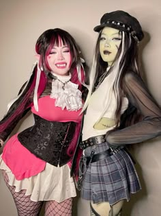 two women dressed in costumes posing for the camera