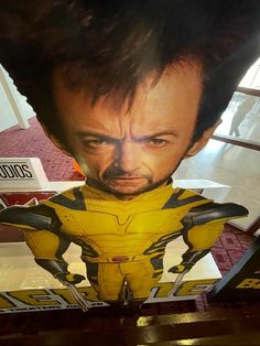 a large cardboard cutout of wolverine is on display in a store window with an advertisement for the upcoming movie