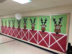 a classroom wall decorated with reindeer heads and snowflakes on the top of it