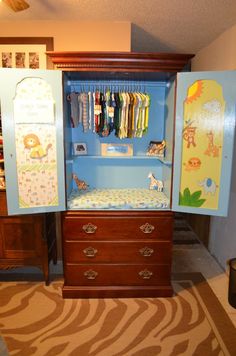 a baby's closet with an armoire and changing table