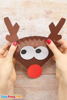 someone is making a paper plate reindeer craft