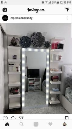 an image of a bedroom with lights on the wall and shelves in front of it