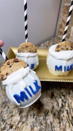 there are three cookies in the shape of milk and chocolate chip on top of each other