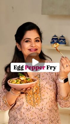 a woman holding a plate with food on it and the caption egg pepper fry