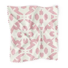 a pink and white animal print fabric with scalloped edges on a white background