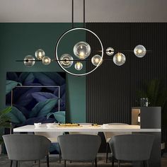 a modern dining room with green walls and white table surrounded by gray chairs, round chandelier hanging from the ceiling