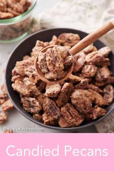 a bowl full of candied pecans with a wooden spoon in it and text overlay