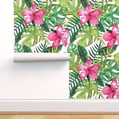 a wall with pink flowers and green leaves on it