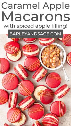 red and white macarons with spiced apple filling on a table next to a bowl of macaroni and cheese