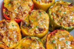 several stuffed peppers with cheese and herbs on top