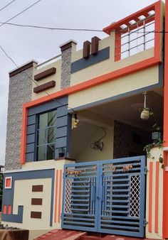 an orange, white and blue house with a balcony