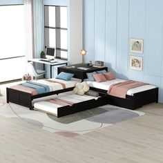 a bed room with two beds sitting next to each other on top of a hard wood floor