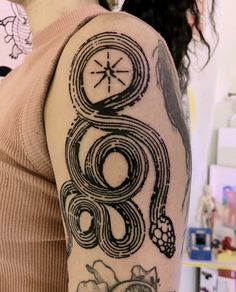 a woman with a clock tattoo on her arm