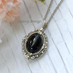 This beautiful locket is adored with Victorian style filigree and a black glass jewel set in the center of the front of the locket.  Size: 24x30mm Chain Lenth: Per Option Finish: Antique Silver Qty: 1pc I also can made this locket necklace with moon stone cabochon, see the second photo Luxury Victorian Pendant Locket Necklace, Luxury Silver Oval Pendant Locket Necklace, Luxury Formal Locket Necklace With Detachable Pendant, Formal Black Locket Necklace, Black Enamel Oval Necklace As Gift, Oval Black Enamel Jewelry Gift, Black Enamel Oval Necklace For Gift, Personalized Black Metal Necklaces, Nickel Free Antique Silver Necklace