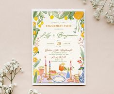 the wedding card is decorated with flowers and candles