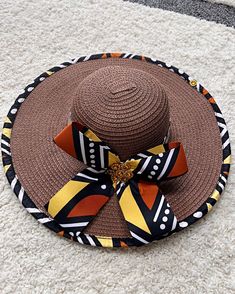 ombines timeless elegance with vibrant cultural flair. Handcrafted with care, this hat features a beautifully woven straw base adorned with bold African print fabric, offering both style and sun protection. Perfect for church services, outdoor events, or simply adding a touch of sophistication to your outfit, this hat blends tradition with modern design. Lightweight and breathable, it's as comfortable as it is striking. Elevate your look with a hat that celebrates heritage and craftsmanship. One size: should fit all. Ankara Bags, Spice Gift, African Print Fabric, Basket Bag, Event Invitation, Outdoor Events, African Fabric, Sun Hat, Print Fabric