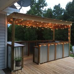 an outdoor bar with lights on the roof