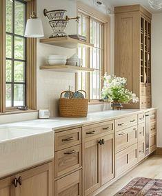 a kitchen filled with lots of wooden cabinets and counter top space next to a window