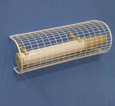 a white wire cage with a roll of toilet paper in it on a blue background