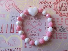 This is a Valentine Heart Beaded Bracelet. It has a white pearl heart pony bead in the middle. It has white and pink solid 8mm faceted beads. It was made with .8mm sturdy stretch string. I tie it several times to prevent breakage. It fits girls ages 5-10. It stretches to fit on the wrist. It would make a cute gift for a little girl for Valentine's Day. It would make a cute gift for a little girl's Birthday. All items are ready to be shipped I do combined shipping. Items ship in 2-5 business days Bracelet Heart, Pearl Heart, Pink Solid, Pony Beads, Heart Beads, Beaded Stretch Bracelet, Plastic Beads, Valentine Heart, Heart Bracelet