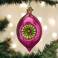 a pink ornament hanging from a christmas tree