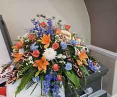 an arrangement of flowers and footballs on a table