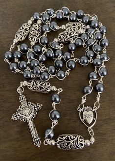 "This beautiful handmade rosary is made with 8mm gray glass, 10mm silver plated beads and 2\" crucifix.   Length: 20\" inches long" Adjustable Silver Crucifix Rosary, Adjustable Silver Rosary With 8mm Beads, Adjustable Silver Rosary With Round Beads, Silver Beaded Rosary With Spiritual Style, Silver Beaded Spiritual Rosary, Spiritual Silver Beaded Rosary, Silver Rosary With Miraculous Medal And Round Beads, Handmade Silver Rosary With Crucifix, Handmade Spiritual Silver Rosary