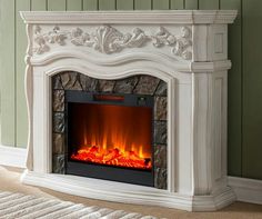 a white fireplace in a living room with green walls