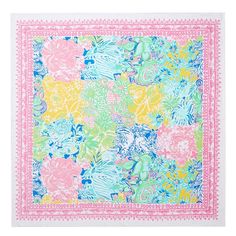 a pink, blue and green square scarf with floral designs on it's edges