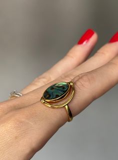 Discover the exquisite elegance of our Abalone Shell Ring, featuring a versatile double-sided design with natural abalone and white shells. Crafted from high-quality brass plated with 18K gold, this luxurious piece embodies nature's beauty and fine craftsmanship. Specifications: - Item Weight: Lightweight and comfortable at 0.06 mils of gold plating. - Metals Type: Stainless Still. - Material: 18K gold plated, combined with natural abalone and white shell. Care Instructions:  * Protect your jewe Gift Rings With Polished Mother Of Pearl Finish, Unique Gold Jewelry With Abalone Shell, Elegant Shell-shaped Ring For Gifts, Gold Mother Of Pearl Rings For Anniversary, Gold Mother Of Pearl Ring For Gift, Gold Mother Of Pearl Anniversary Rings, Adjustable Gold Shell Ring, Oval Mother Of Pearl Ring With Polished Finish, Gold Mother Of Pearl Ring As A Gift