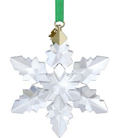 a snowflake ornament with a green ribbon hanging from it's side