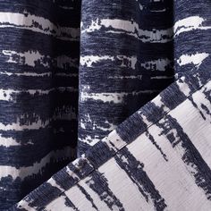 three pieces of blue and white fabric with different patterns on them, one is folded over the other