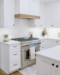 a kitchen with white cabinets and an oven