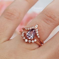 Gorgeous Alexandrite Ring Set ►Base Metal: Sterling Silver (925) ►Plating: 14K Rose Gold Vermeil ►Accented With Simulated Diamonds (CZ) ►Free wedding band is included Center Stone: Alexandrite Color: Purple/Pink/Blue Stone cut: Teardrop Gem size: 9.0x 6.0 mm Average Carat Weight: 1.5 ct. Gemstone creation: 100% Genuine Lab-Grown Alexandrite Stone Origin: Russia Hardness: 8.5 (Mohs scale) ►The color of Alexandrite changes under different lighting conditions. If viewed in daylight, its color is pu Rose Gold Sapphire Ring For Wedding, Classic Rose Gold Stackable Gemstone Rings, Classic Rose Gold Stackable Rings With Gemstones, Rose Gold Sapphire Ring With Prong Setting For Wedding, Delicate 14k Rose Gold Wedding Rings, Delicate Wedding Rings In 14k Rose Gold, 14k Rose Gold Sapphire Ring For Wedding, Rose Gold 14k Stackable Wedding Rings, Wedding Stackable 14k Rose Gold Rings