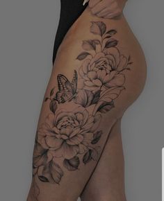 a woman's thigh with flowers and a butterfly on it