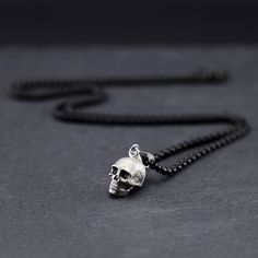 Sterling silver pendant in the shape of a human skull. Skull made of sterling silver, oxidized and matt finished, goth design. Dimensions: 9 X 11 mm. Stainless steell chain, black color. All our jewelry is hand-made and so sizes may vary from the standard slightly. If you have any questions about this product do not hesitate to contact us. Gothic Silver Necklace With Skull Print, Black Skull Necklace With Oxidized Finish, Black Oxidized Skull Necklace, Silver Oxidized Skull Necklace, Goth Design, Skull Love, Dark Skull, Skull Pendant Necklace, Gothic Skull