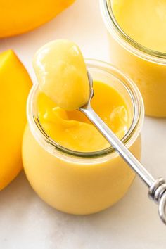 mango curd in small glass jars with a spoon on the side and text overlay that reads how to make mango curd