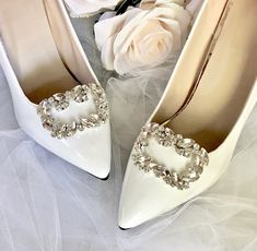 the brides shoes are adorned with crystal heart brooches and white tulle